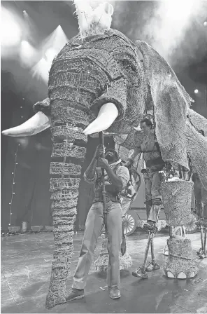  ?? PHOTOS BY ROBERT HANASHIRO, USA TODAY ?? Queenie is operated by three puppeteers, two of whom are on stilts. The elephants are a part of Circus 1903, which begins its U. S. tour in Los Angeles. At left, Peanut stands on hind legs at the command of the ringmaster.