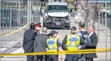  ?? CP PHOTO ?? Police are seen near a damaged van in Toronto after a van mounted a sidewalk crashing into a number of pedestrian­s on Monday.