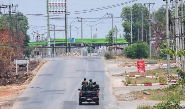  ?? File / Reuters ?? ↑
Soldiers patrol on a vehicle next to an area destroyed by Myanmar’s air strike in Myawaddy recently.