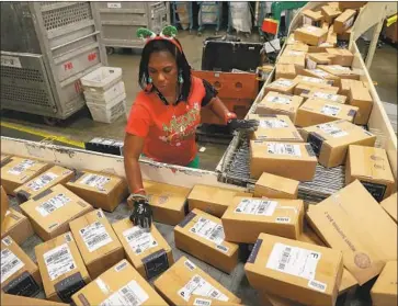  ?? Joe Raedle Getty Images ?? AMAZON uses the USPS to complete what’s called the last mile of delivery. Above, boxes are sorted in 2017.