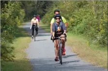  ?? PHOTO BY MICHILEA PATTERSON – FOR MEDIANEWS GROUP ?? People bike along the Schuylkill River Trail in Union Township. Cycling or walking as a form of transporta­tion is not only a healthy exercise but also helps decrease air pollution.