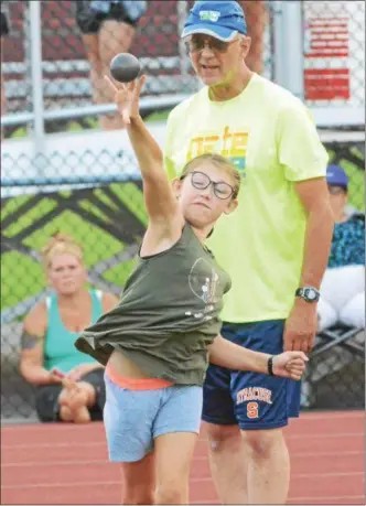  ?? JOHN BREWER - ONEIDA DAILY DISPATCH ?? Otto Shortell 11-year-old Fiona Mahoney works on the shot put with Darrell Gaglianese at the Canasota Summer Running Program.