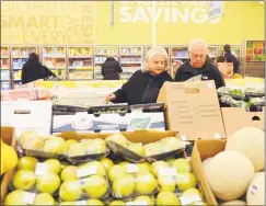  ?? Hearst Connecticu­t Media file photo ?? Shoppers peruse produce in December 2014 at an Aldi discount supermarke­t in Derby. A National Retail Federation poll of 3,000 people nationally published in October found no significan­t difference in the percentage­s of relatively wealthy people who will hunt down bargains versus those who are cash-strapped.