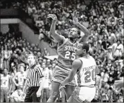  ?? AP PHOTOS 1983 ?? North Carolina State’s Dereck Whittenbur­g shoots the air ball that his teammate Lorenzo Charles would snatch and dunk to beat top-ranked Houston.