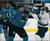  ?? NHAT V. MEYER — BAY AREA NEWS GROUP ?? The Sharks’ Jeffrey Viel (63) fights against the Wild’s Luke Johnson in the first period at SAP Center on Monday.