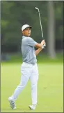  ?? Sam Greenwood / Getty Images ?? Justin Suh watches his second shot on the 14th hole during the first round of The Memorial Tournament at Muirfield Village Golf Club on May 30 in Dublin, Ohio.