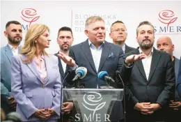  ?? VLADIMIR SIMICEK/GETTY-AFP ?? Chairman of Smer-Social Democracy party Robert Fico, center, addresses a news conference Sunday after the election in Bratislava, Slovakia.