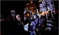  ?? REUTERS/JAMES LAWLER DUGGAN ?? Demonstrat­ors against US President-elect Donald Trump march along the inaugural parade route outside the Trump Internatio­nal Hotel on Pennsylvan­ia Avenue in Washington on Thursday.