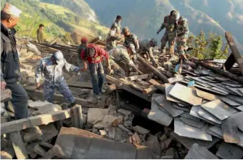  ?? — AP ?? Indian Armymen help in rescue and relief operations in Nepal after a poweful earthquake hit the Himalayan nation on April 25.
