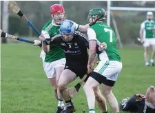  ??  ?? Kevin Banks brushes past 2 Fermanagh players. Pic: Donal Hackett.