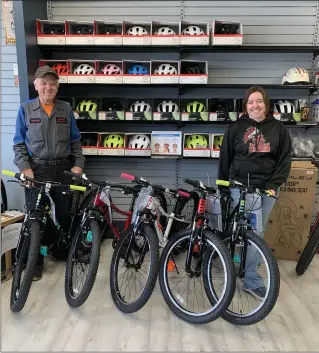  ?? LYN DEAL — SPECIAL TO THE TIMES ?? Owner of Bicycle Adventure, Richard Lapp, stands with his store manager, Brianna Everhart, accompanie­d by the bikes they will be awarding on April 1.