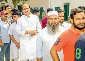  ?? — PTI ?? BJP MLA Suresh Rana, (4th from right), waits in a queue to cast his vote for Kairana parliament­ary constituen­cy bypolls in Shamli on Monday.