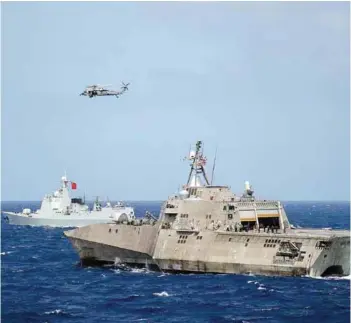  ?? PHOTOGRAPH: US Navy ?? US Navy littoral combat ship USS Coronado (LCS 4) and the People’s Republic of China Navy guided-missile destroyer Xian (153) transit in formation during the Rim of the Pacific 2016