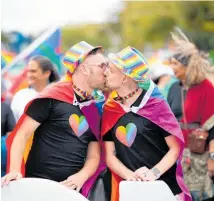  ?? Photos / Andrew Warner; Sylvie Whinray; Supplied ?? Showing affection in public, as this couple is in Auckland’s 2021 Rainbow Pride Parade, was more dangerous for gay men in the 1970s.