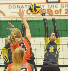  ??  ?? Cornerston­e’s Eva Gray gets her hand on a kill attempt by Peacock’s Olivia Mowchenko.