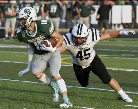  ?? RANDY MEYERS — FOR THE MORNING JOURNAL ?? Elyria Catholic’s Colin Ginley turns upfield after making a catch against Kaiden Weyer of Perkins on Aug. 27.