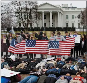  ?? AP/EVAN VUCCI ?? Demonstrat­ors who support stronger gun-control laws participat­e in a “lie-in” in front of the White House on Monday in Washington.