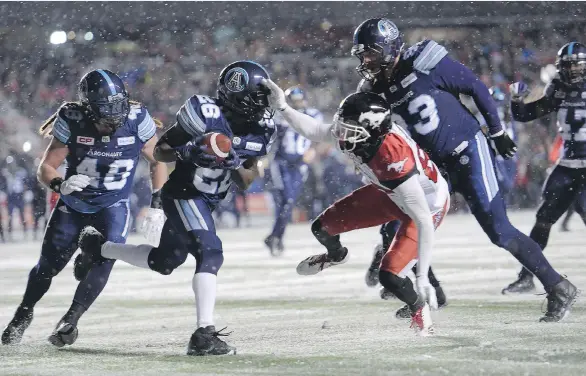  ?? PAUL CHIASSON/THE CANADIAN PRESS ?? Toronto Argonauts defensive back Cassius Vaughn, centre left, recovers the football on a fumble by Calgary Stampeders slotback Kamar Jorden, centre right, during the second half of the 105th Grey Cup on Sunday in Ottawa. Vaughn had a 109-yard play...