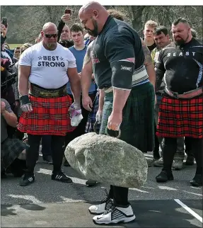  ??  ?? FEAT OF STRENGTH: Brian Shaw setting his record for carrying Dinnie Stones