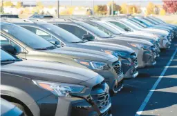  ?? DAVID ZALUBOWSKI/AP 2022 ?? A row of 2023 Subaru Outback SUVs sits in a dealership lot in Loveland, Colo. Automakers sold 3.59 million vehicles during the first three months of this year.