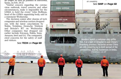  ?? Chinatopix via AP ?? Workers watch a container ship arrive Feb. 4 at a port in Qingdao in east China’s Shandong province. Factories across China are still closed to try to limit spread of the coronaviru­s, leaving businesses in limbo.