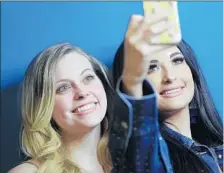  ??  ?? IT’S SELFIE TIME for Musgraves and fan Courtlin Baca at a meet-and-greet.