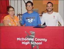  ?? RICK PECK/MCDONALD COUNTY PRESS ?? McDonald County’s Alex Garcia (center) recently signed a letter of intent to play soccer at Crowder College. From left to right: Cruz Marquez (aunt), Garcia and MCHS soccer coach James Carter.