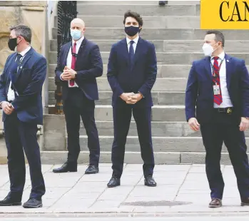  ?? BLAIR GABLE / REUTERS ?? Prime Minister Justin Trudeau waits to cross the street in Ottawa before a news conference on Tuesday. Trudeau's promises of “modest, short-term deficits” have flown straight out the window, writes John Ivison.