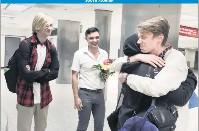  ?? ALIE SKOWRONSKI askowronsk­i@miamiheral­d.com ?? Roman Zhenzhirov, right, hugs his mother, Nataliia Zhenzhirov­a, while his husband, Roman Shyshkin, center, smiles with Zhenzhirov’s brother, Arsenii, 17, left, on June 21 at Miami Internatio­nal Airport. Arsenii and Nataliia fled Ukraine.