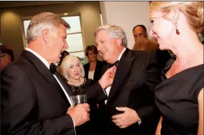  ??  ?? Gov. Mike and Ginger Beebe check out the Jolly Roger bow tie of John Goodson
of Fayettevil­le, here with the Hon. Courtney Hudson Goodson