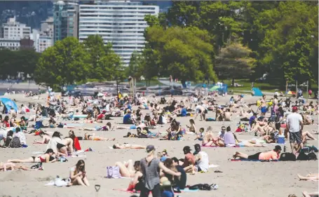  ?? DARRYL DICK/THE CANADIAN PRESS ?? As public pandemic restrictio­ns lifted, hundreds gathered unnecessar­ily in places like Vancouver’s Kitsilano Beach.