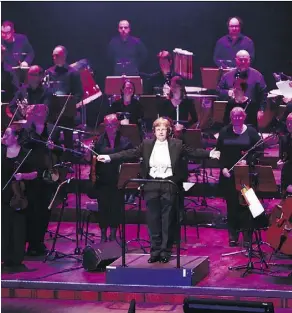  ?? MICHAEL PROBST/THE ASSOCIATED PRESS ?? Conductor Johanna Weitkamp performs with the SAP orchestra in Mannheim, Germany. Some big corporatio­ns think performing symphonies helps employees team up on projects at work.