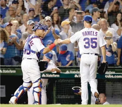  ?? NAM Y. HUH/AP ?? Starting pitcher Cole Hamels is congratula­ted by catcher Willson Contreras after the seventh inning.