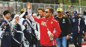  ?? Reuters ?? Ferrari’s Sebastian Vettel waves to the fans before the start of the race at Baku City Circuit yesterday.