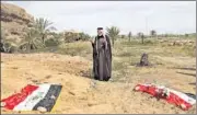  ?? AP FILE ?? An Iraqi man prays for his slain relative at the site of a mass grave believed to contain the bodies of Iraqi soldiers killed by Islamic State militants in Camp Speicher military base in 2014.