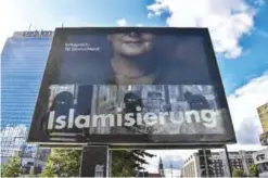  ??  ?? BERLIN: A revolving billboard features a poster showing the Christian Democratic Union’s main candidate German Chancellor Angela Merkel (top) and a poster from the far-right Alternativ­e for Germany (AfD) (bottom) featuring the sentence “Stop...