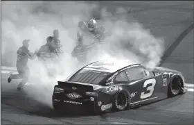  ?? AP/JOHN RAOUX ?? Austin Dillon (in helmet) celebrates with his crew after winning the Daytona 500 Sunday at Daytona Internatio­nal Speedway in Daytona Beach, Fla.