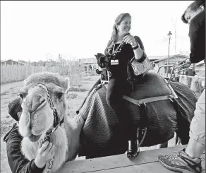  ?? SAM GREENE DISPATCH ?? Volunteer Sue Repke rides a camel in the Heart of Africa exhibit at the Columbus Zoo and Aquarium. Among other attraction­s, visitors can go for a spin on the humped animals.