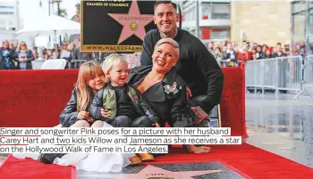  ?? Photos by AFP, AP and Reuters ?? Singer and songwriter Pink poses for a picture with her husband on the Hollywood Walk of Fame in Los Angeles.