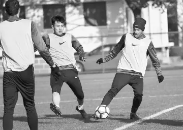  ??  ?? This file picture taken on Jan 21 shows Argentine striker Carlos Tevez (right) taking part in his first training session with his new club Shanghai Shenhua in Shanghai. — AFP photo