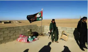  ?? ( Reuters) ?? MEMBERS OF a Shia militia guard a house in Iraq. The new NDAA warns about the presence of Iranian- backed militias.