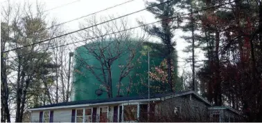  ?? PUBLIC RECORD/YORK WATER DISTRICT ?? The 71-foot Roots Rock Road water tank is clearly visible from Huckins Avenue in York, Maine, as pictured here in November 2019. A proposal would add more cellular antennas atop the tank.