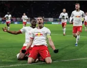  ??  ?? Leipzig’s midfielder Marcel Sabitzer (front) celebrates with defender Nordi Mukiele after scoring during their UEFA Champions League match against Tottenham on Tuesday. Lepizig won 3-0 advance on 4-0 aggregate.—AFP