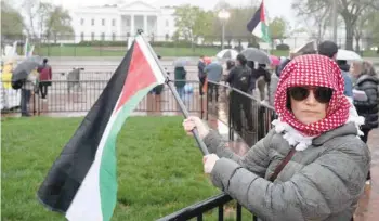  ?? — AFP ?? Pro-palestinia­n demonstrat­ors wave Palestinia­n flags as they call for a ceasefire in Gaza during a protest as part of the “People’s White House Ceasefire Now Iftar” outside the White House in Washington, DC.