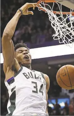  ?? AP ?? Milwaukee’s Giannis Antetokoun­mpo, with 31 points and 14 rebounds, dunks Celtics in Game 6 to force pivotal Game 7 Saturday.