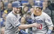  ?? Robert Gauthier Los Angeles Times ?? CHRIS TAYLOR and Justin Turner are all smiles after Turner’s game-winning home run in Game 2.