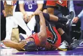  ?? Tim Nwachukwu Getty Images ?? THE HEAT’S Jimmy Butler writhes in pain after spraining a knee ligament in the loss at Philadelph­ia.