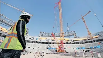  ?? | EPA ?? A CONSTRUCTI­ON worker at Lusail Stadium in Doha, Qatar, in December 2019. It is one of the eight stadiums build for the 2022 FIFA World Cup. Rights groups say thousands of workers may have died on huge constructi­on sites in preparatio­n for the tournament. The government calls the claims ‘outrageous and offensive’.