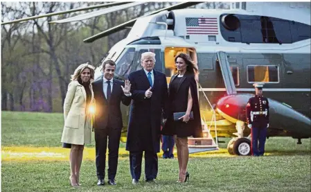  ??  ?? Landmark meeting: Macron and Brigitte with Trump and US First Lady Melania Trump posing for photograph­ers before boarding Marine One after dinner at Mount Vernon. — Bloomberg