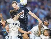  ?? Carlos Gonzalez ?? BRENT KALLMAN, at top, scores on a header for Minnesota United late in the first half against LAFC.